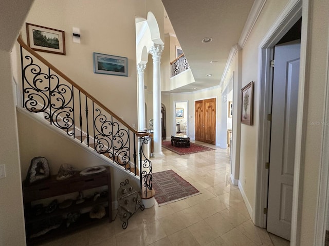8734 Crestgate Cir, Orlando, FL 32819 - foyer entrance featuring ornate columns, crown molding, light tile patterned floors, baseboards, and recessed lighting