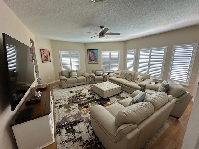 8734 Crestgate Cir, Orlando, FL 32819 - living area featuring ceiling fan, a textured ceiling, and baseboards