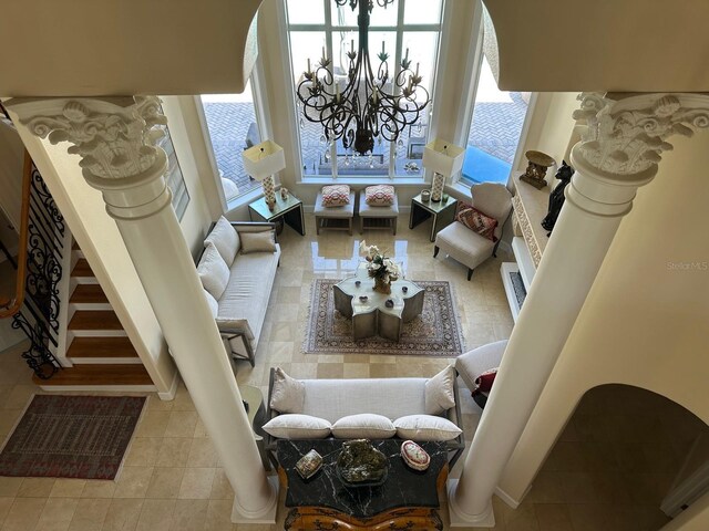 8734 Crestgate Cir, Orlando, FL 32819 - living room featuring a chandelier, tile patterned flooring, and baseboards