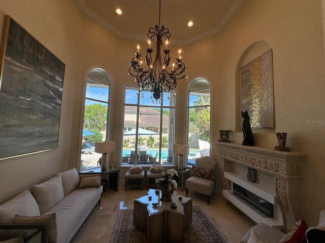 8734 Crestgate Cir, Orlando, FL 32819 - living area featuring a high ceiling, ornamental molding, a chandelier, and recessed lighting