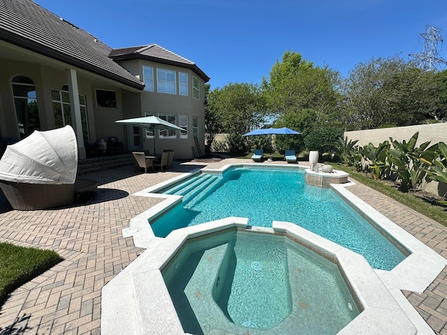 8734 Crestgate Cir, Orlando, FL 32819 - view of swimming pool featuring a pool with connected hot tub and a patio