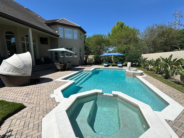 8734 Crestgate Cir, Orlando, FL 32819 - view of swimming pool featuring a pool with connected hot tub and a patio