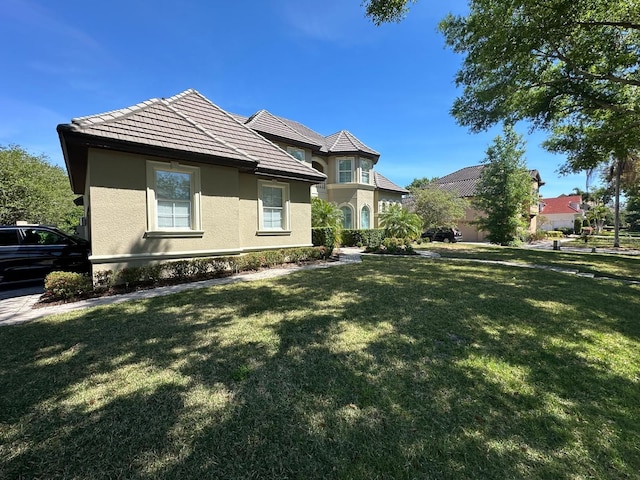 8734 Crestgate Cir, Orlando, FL 32819 - view of front facade featuring stucco siding and a front lawn