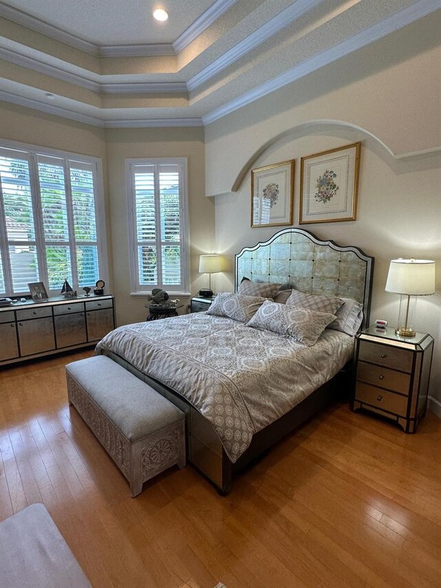 8734 Crestgate Cir, Orlando, FL 32819 - bedroom featuring ornamental molding, a raised ceiling, hardwood / wood-style flooring, and recessed lighting