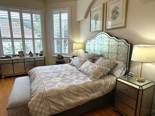 8734 Crestgate Cir, Orlando, FL 32819 - bedroom with wood finished floors and multiple windows