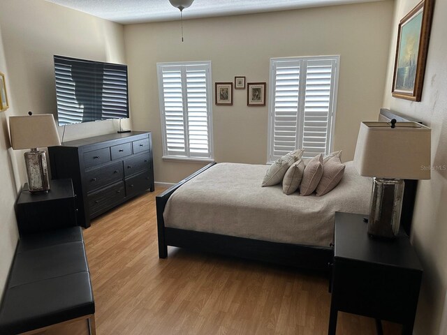 8734 Crestgate Cir, Orlando, FL 32819 - bedroom with light wood finished floors and baseboards