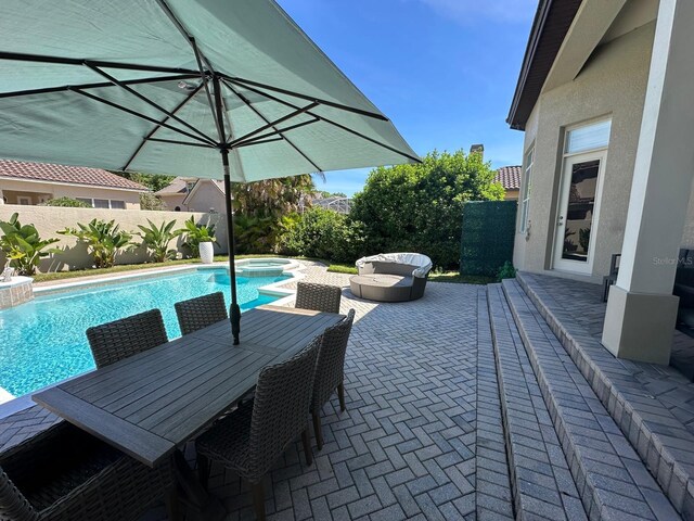 8734 Crestgate Cir, Orlando, FL 32819 - view of pool featuring a patio area, a fenced backyard, a pool with connected hot tub, and outdoor dining space