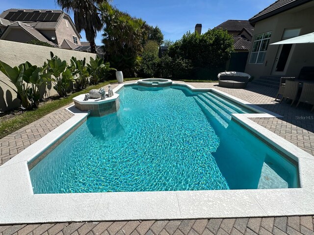 8734 Crestgate Cir, Orlando, FL 32819 - view of swimming pool with a patio area, a fenced backyard, and a pool with connected hot tub