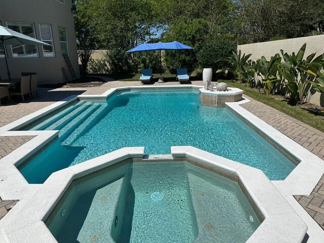 8734 Crestgate Cir, Orlando, FL 32819 - view of swimming pool with a pool with connected hot tub and a patio
