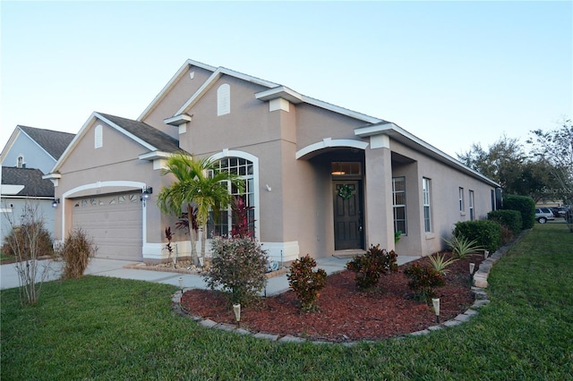 view of front of home featuring a front yard and a garage