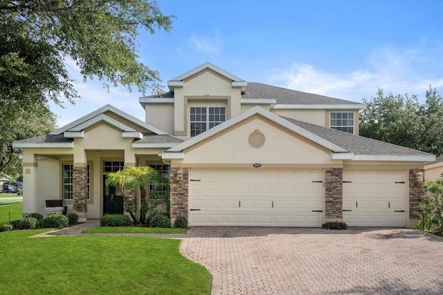 view of front of property featuring a garage and a front yard