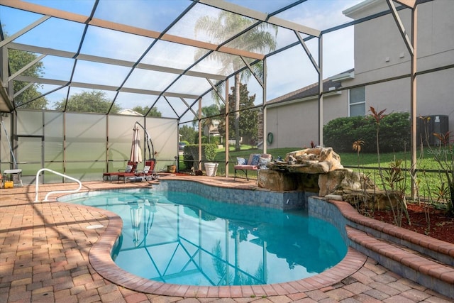 view of swimming pool with a lanai and a patio