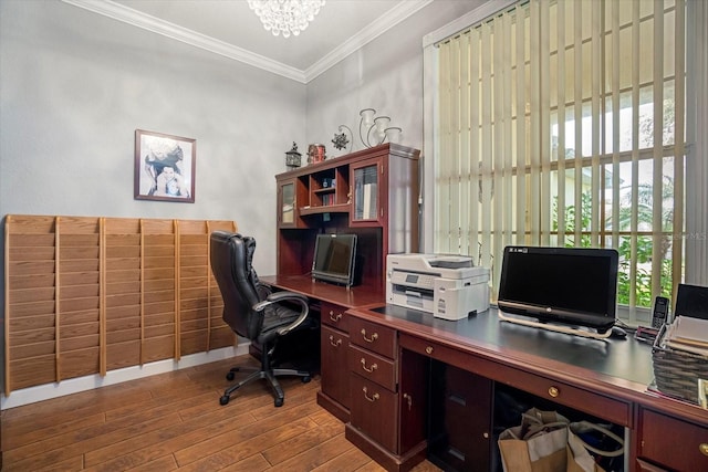 office with an inviting chandelier, hardwood / wood-style floors, ornamental molding, and a healthy amount of sunlight