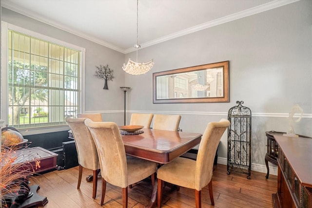 dining area featuring crown molding and hardwood / wood-style flooring