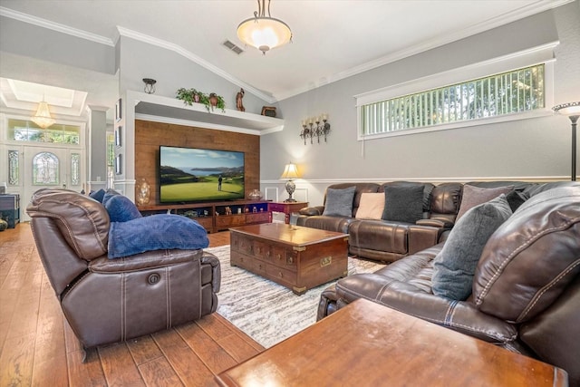 living room featuring crown molding, vaulted ceiling, and hardwood / wood-style floors