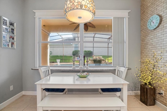 tiled dining space featuring ceiling fan