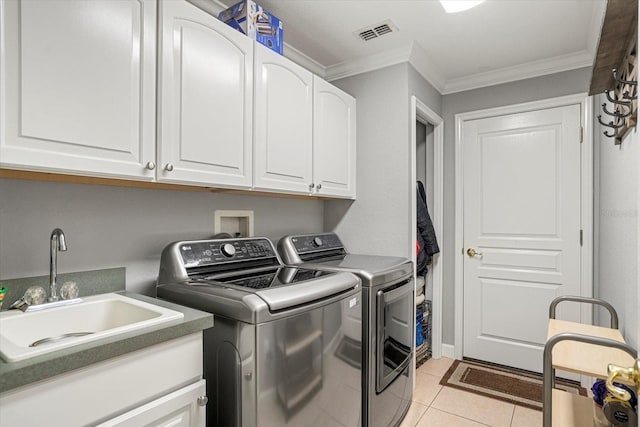 laundry area featuring light tile patterned flooring, sink, cabinets, ornamental molding, and independent washer and dryer