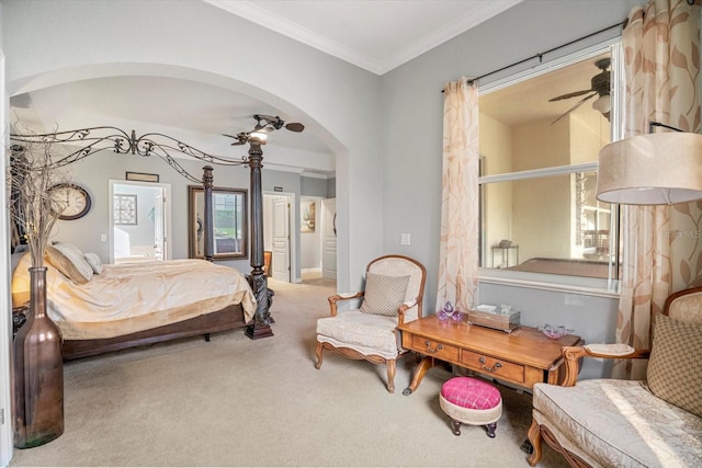 carpeted bedroom with connected bathroom, crown molding, and ceiling fan