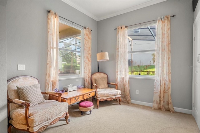 sitting room with ornamental molding, plenty of natural light, and light colored carpet