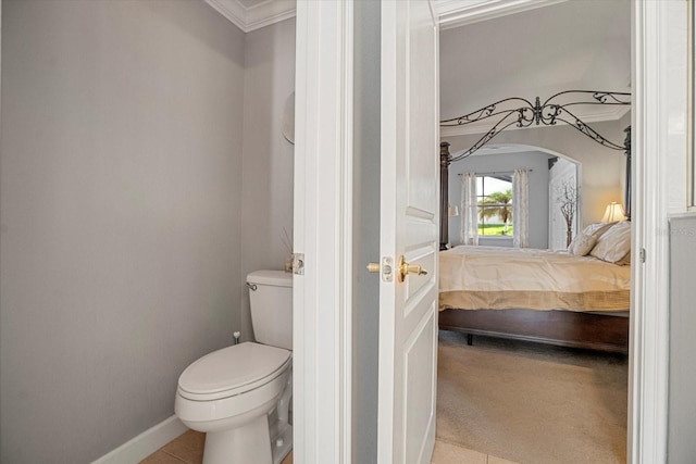 bathroom featuring ornamental molding, tile patterned floors, and toilet