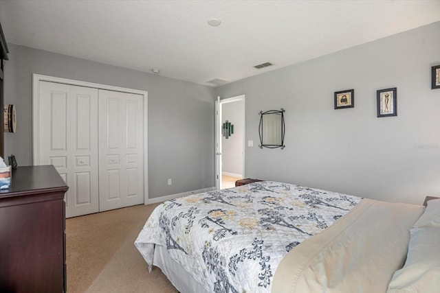 bedroom featuring light colored carpet and a closet