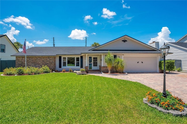 single story home with a garage and a front lawn