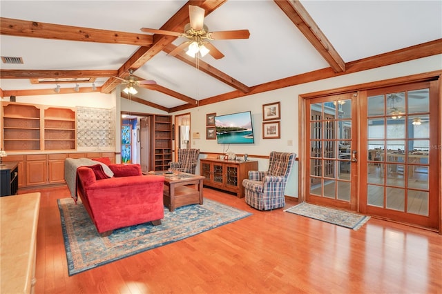 living room with french doors, built in shelves, ceiling fan, vaulted ceiling with beams, and light hardwood / wood-style floors