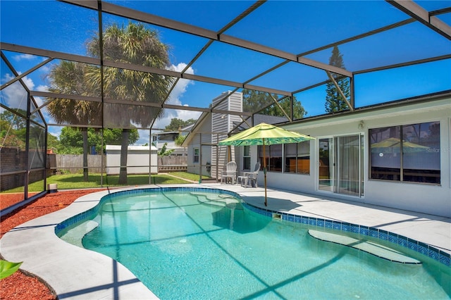 view of swimming pool with a lanai and a patio area