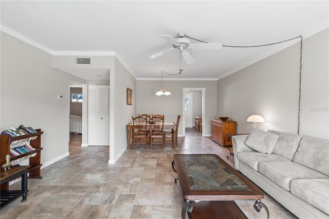 living room with ceiling fan with notable chandelier and crown molding