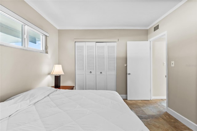 bedroom featuring a closet and crown molding