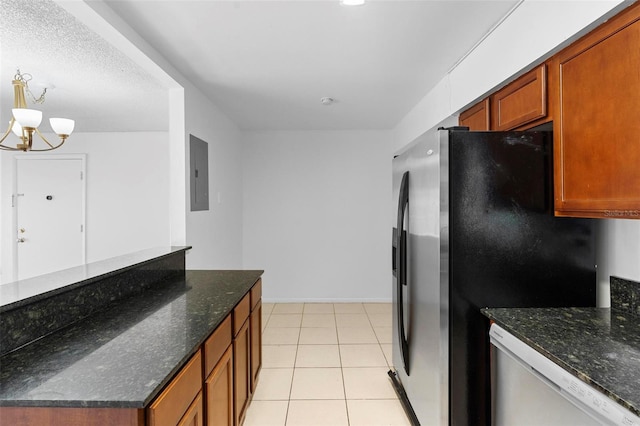 kitchen with electric panel, stainless steel appliances, a chandelier, and dark stone countertops