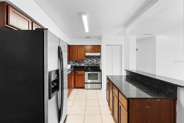 kitchen with stainless steel appliances, decorative backsplash, light tile patterned floors, and kitchen peninsula