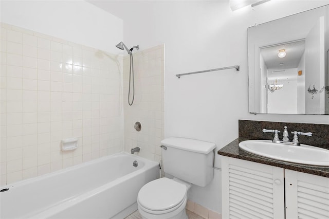 full bathroom featuring toilet, tiled shower / bath combo, and vanity