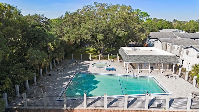 view of swimming pool featuring a patio and a hot tub