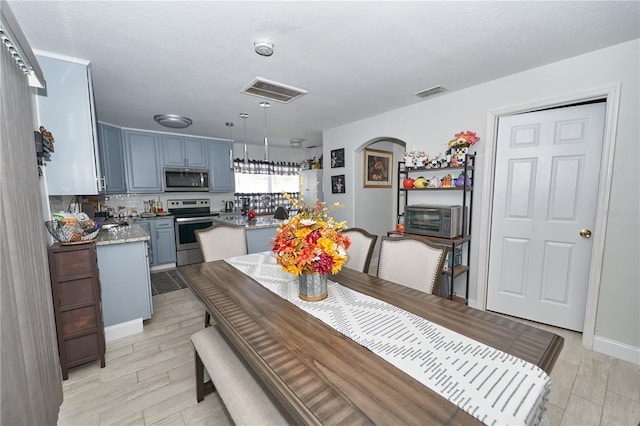 dining room featuring sink and a textured ceiling