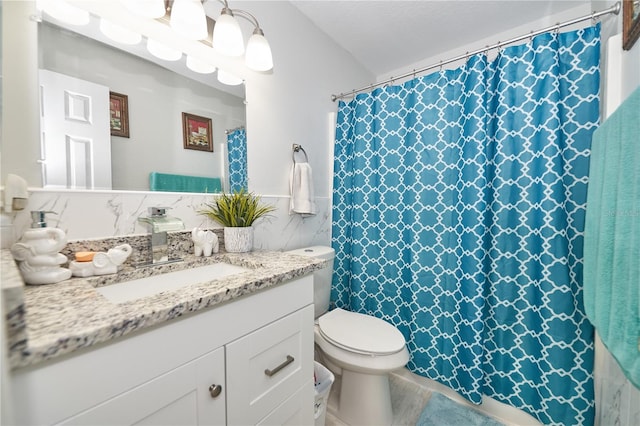 bathroom featuring vanity, a textured ceiling, and toilet