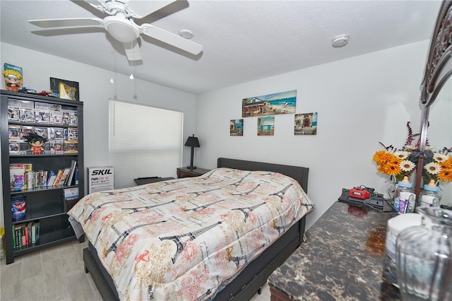 bedroom featuring light wood-type flooring and ceiling fan