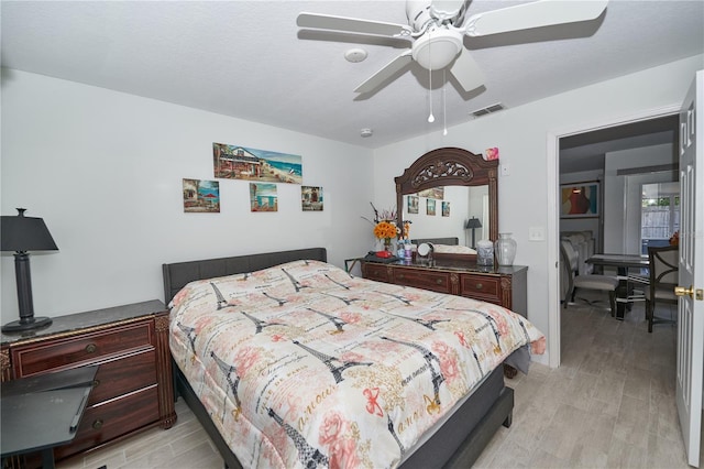 bedroom with light hardwood / wood-style flooring and ceiling fan