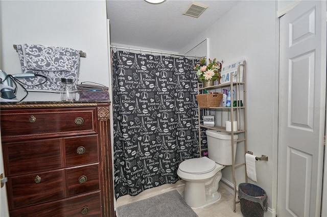 bathroom with vanity, tile patterned flooring, toilet, and a textured ceiling