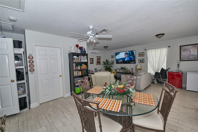 dining space with a textured ceiling and ceiling fan