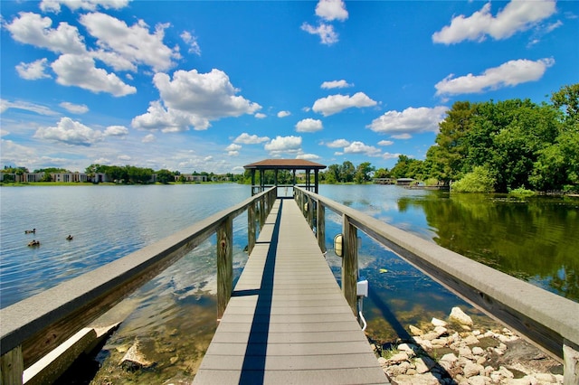 view of dock with a gazebo and a water view