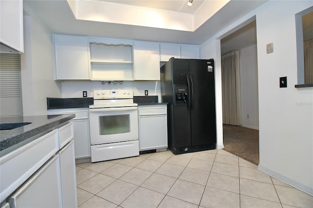 kitchen featuring light tile patterned flooring, white cabinets, electric range, a raised ceiling, and black fridge