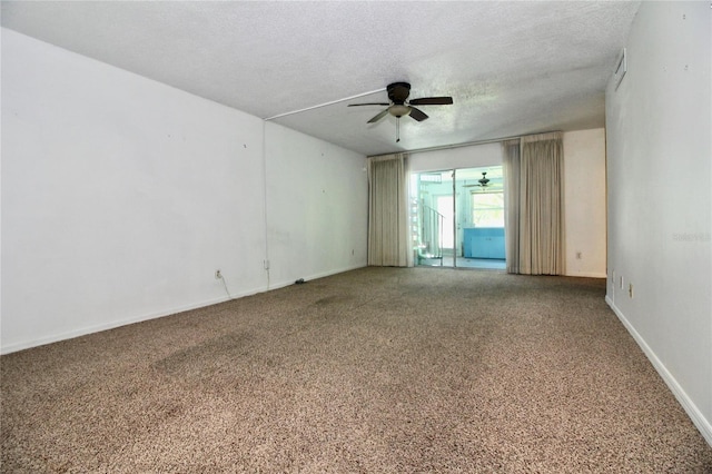 spare room featuring ceiling fan, carpet floors, and a textured ceiling