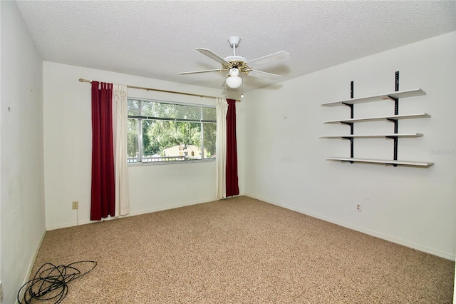 carpeted spare room with ceiling fan and a textured ceiling