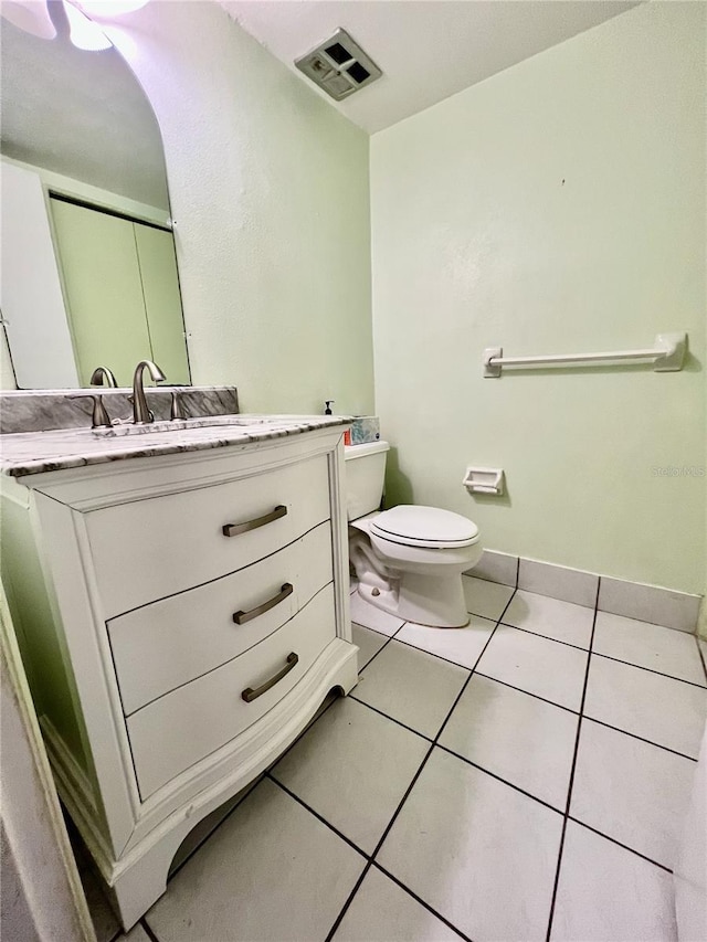 bathroom featuring tile patterned floors, visible vents, toilet, and vanity