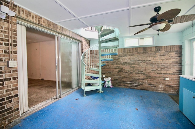 view of patio featuring stairs and a ceiling fan