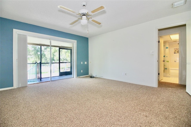 unfurnished room featuring a ceiling fan, carpet, and visible vents