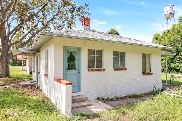 exterior space featuring entry steps and roof with shingles