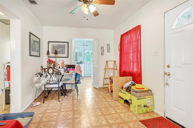 entrance foyer featuring light parquet floors and ceiling fan