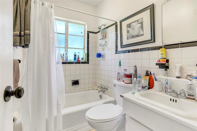 full bathroom featuring vanity, shower / bath combo, tile walls, and toilet